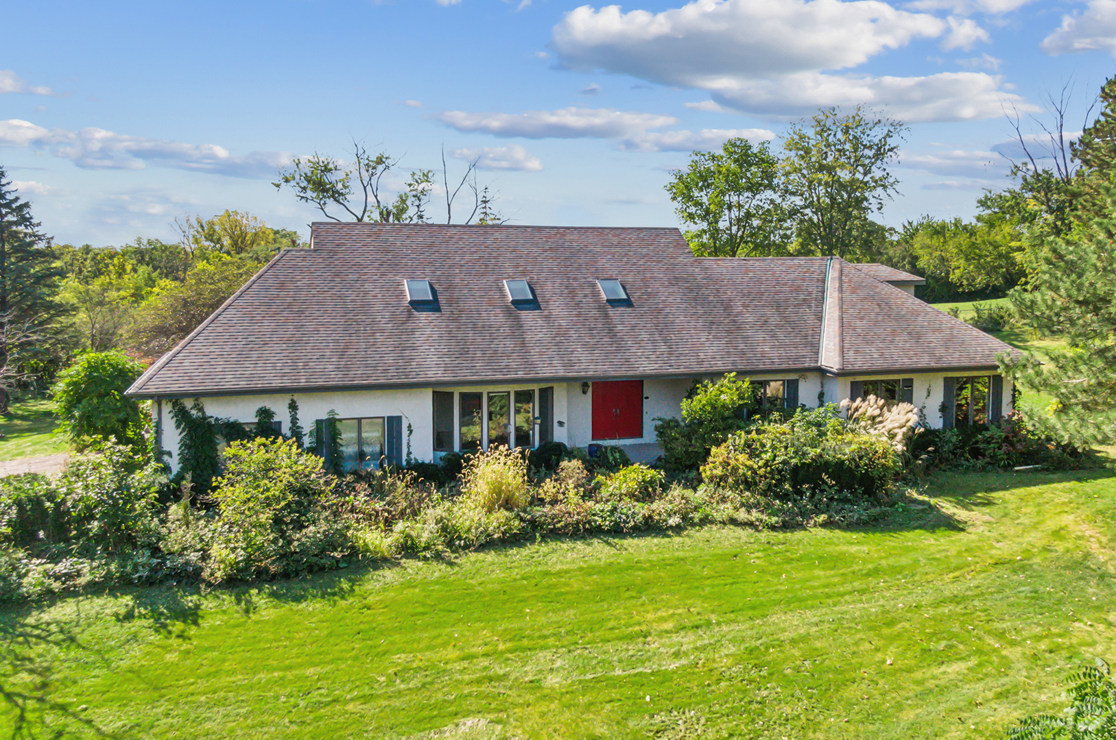 a aerial view of a house next to a yard