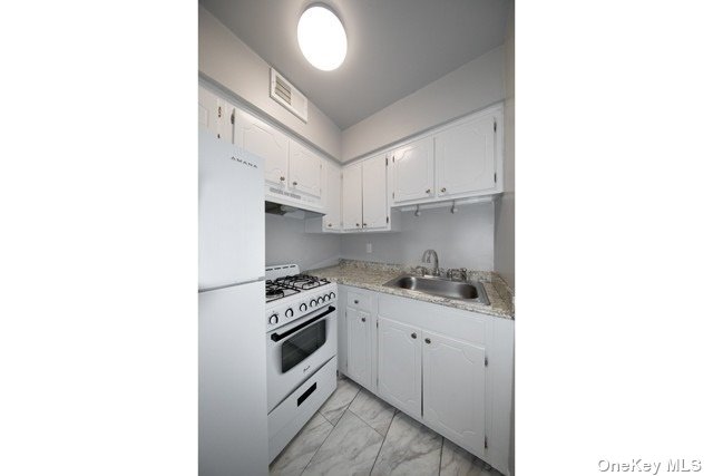 a kitchen with stainless steel appliances granite countertop a sink and cabinets