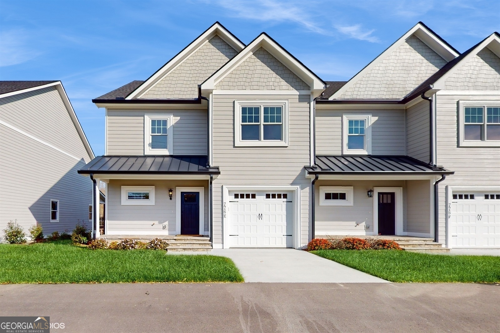 a front view of a house with a garden and garage