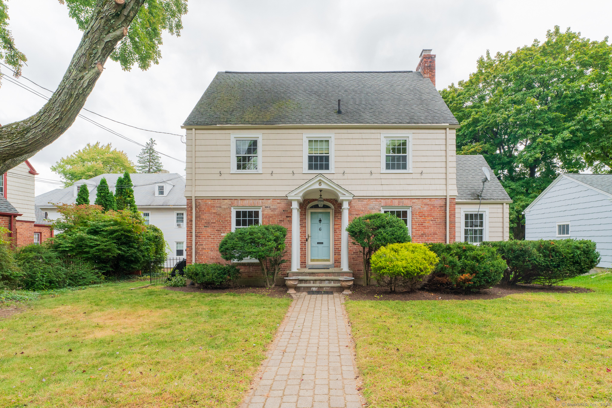 a front view of a house with garden