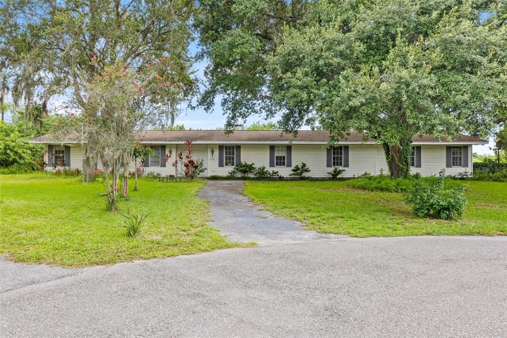 a front view of house with yard and green space