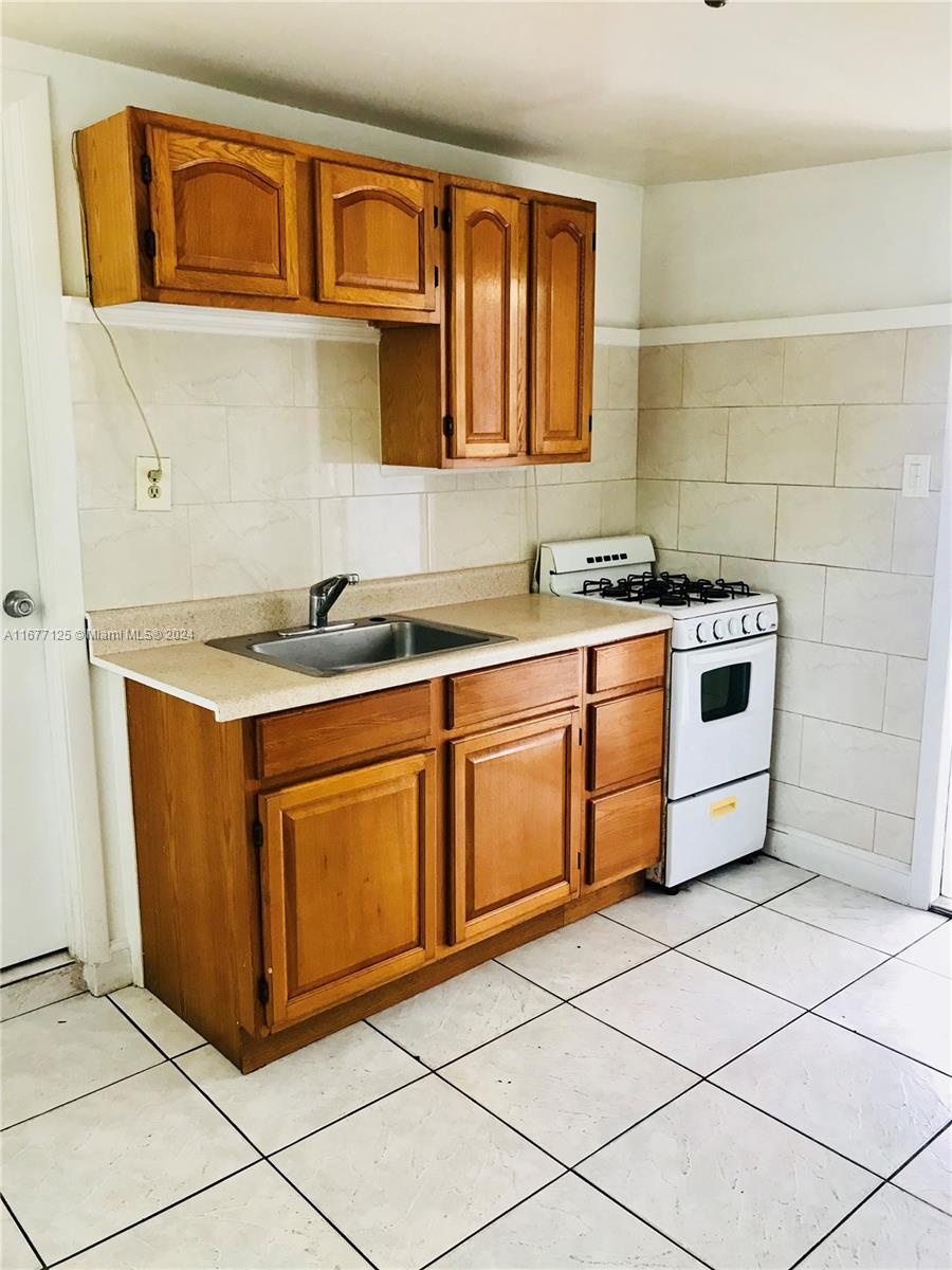 a kitchen with stainless steel appliances granite countertop a stove sink and cabinets