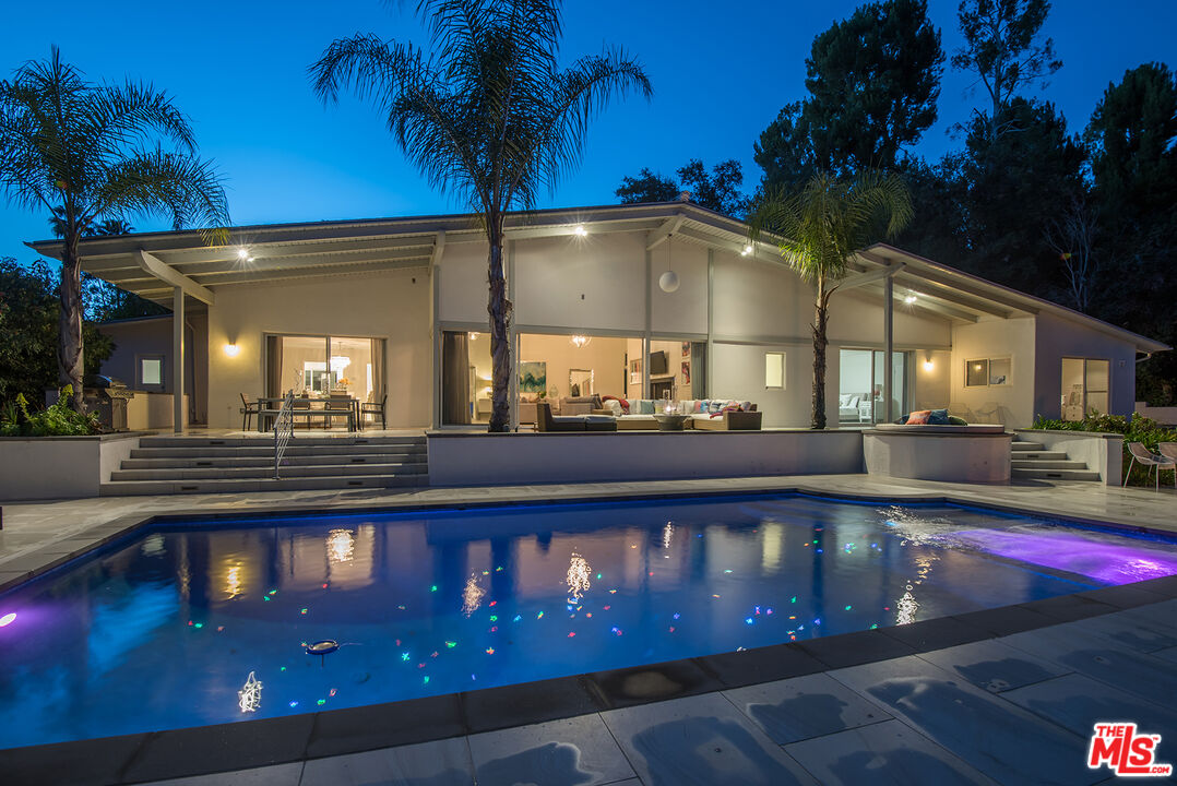 a view of a swimming pool with an outdoor space and seating area