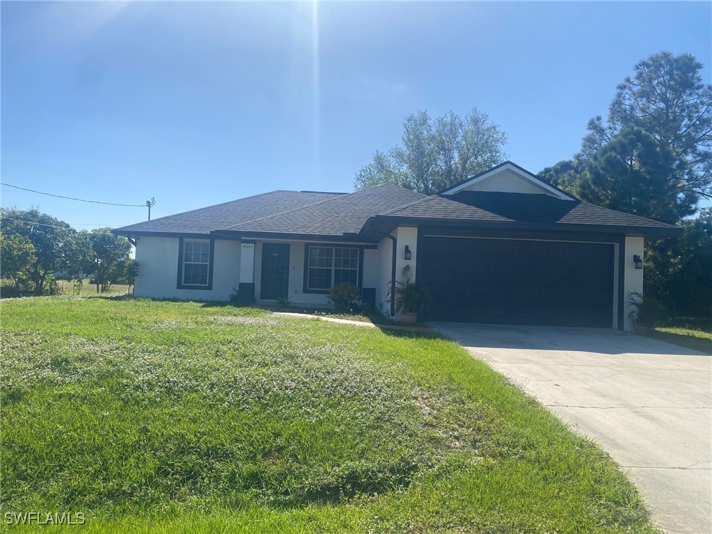 a front view of a house with a yard and garage