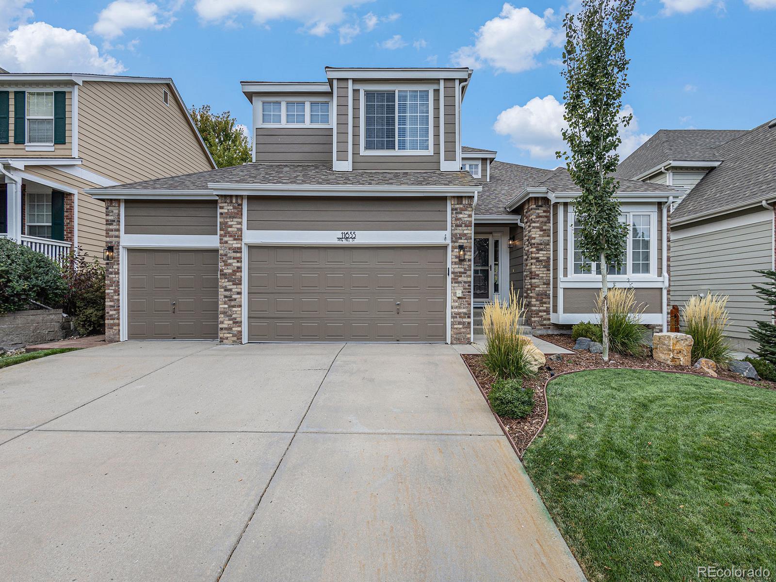 a front view of a house with a yard and garage