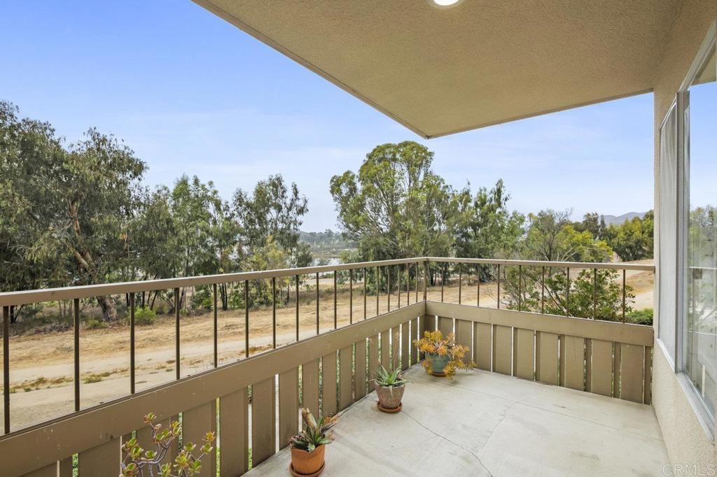 a balcony with trees in front of it