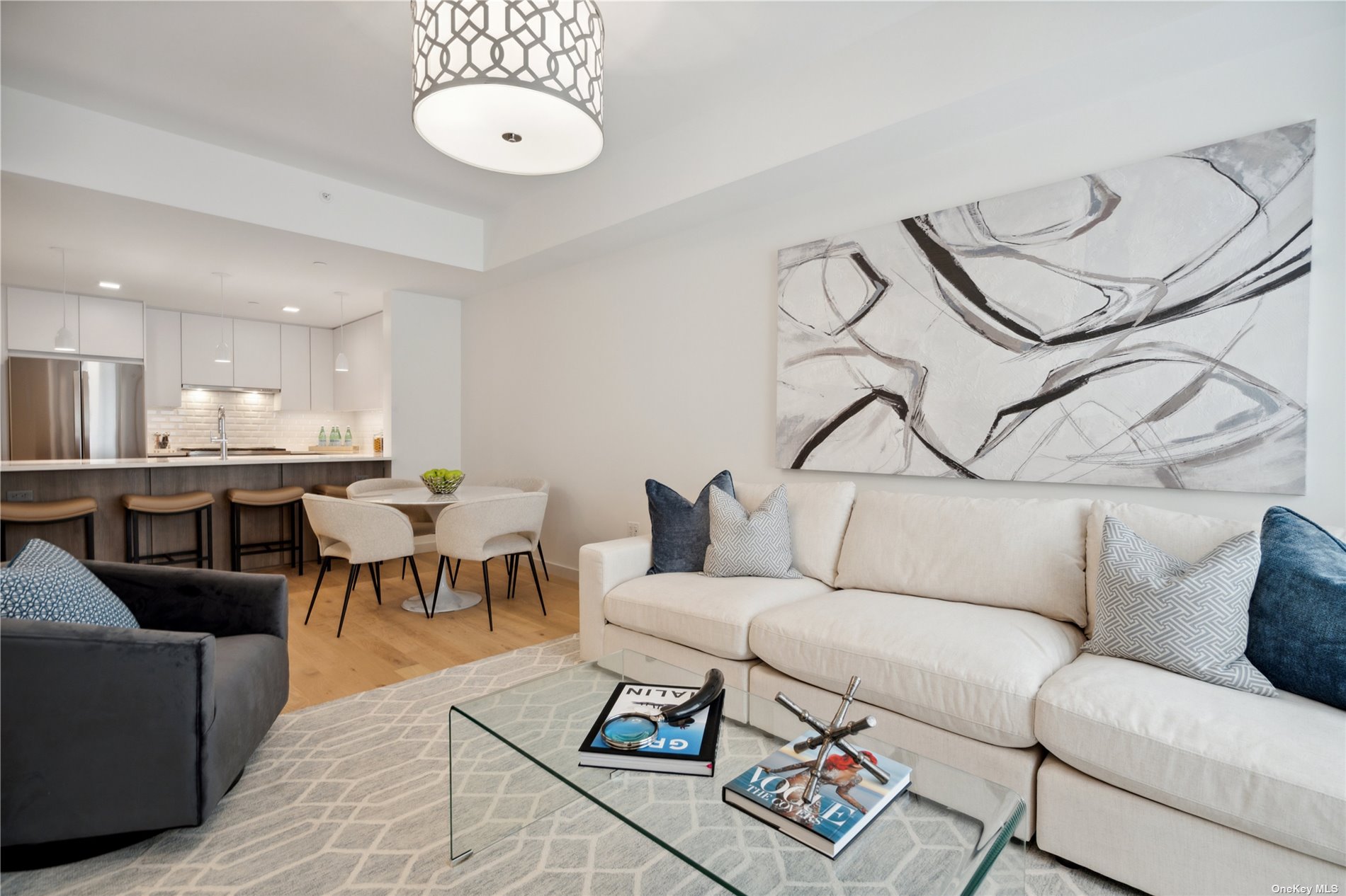 a living room with furniture a rug and a chandelier