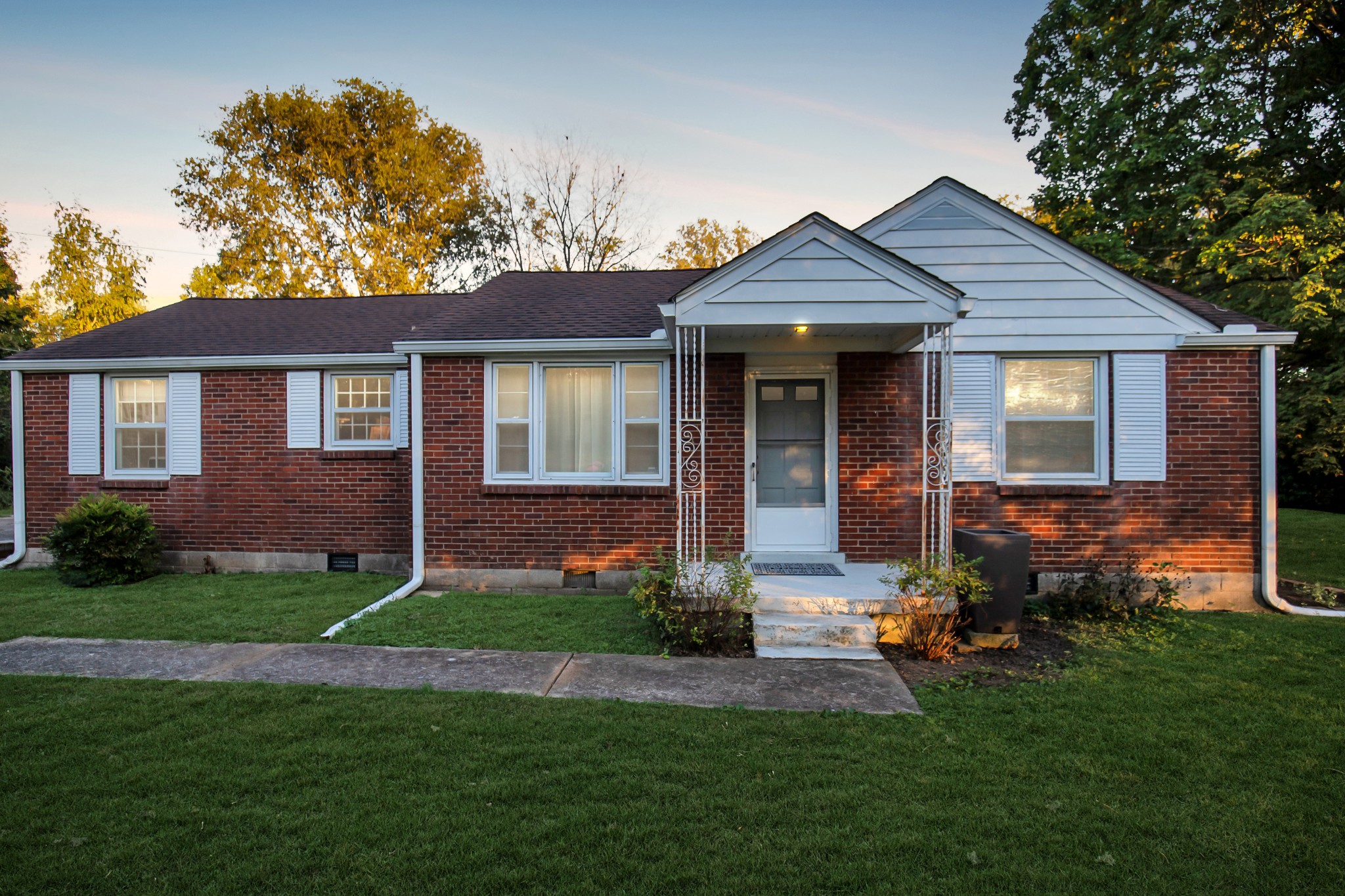 a front view of a house with a yard and porch