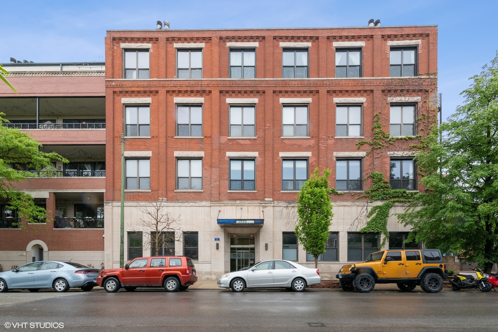 a view of a cars park in front of a building