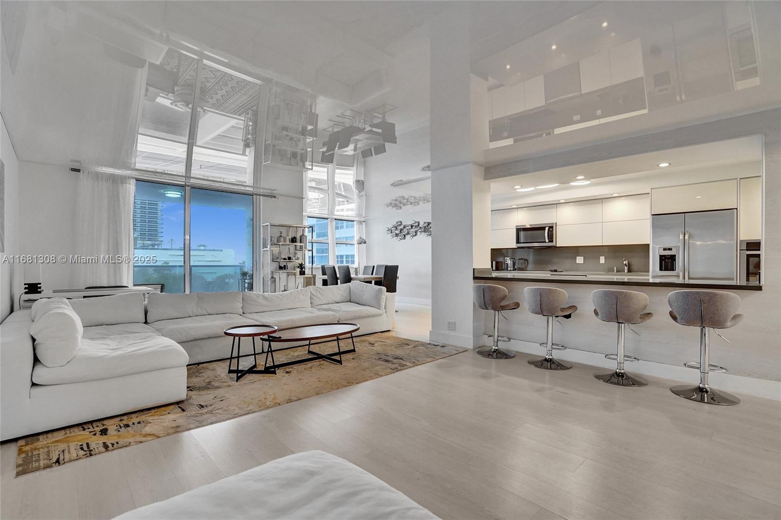 a living room with furniture and a kitchen view