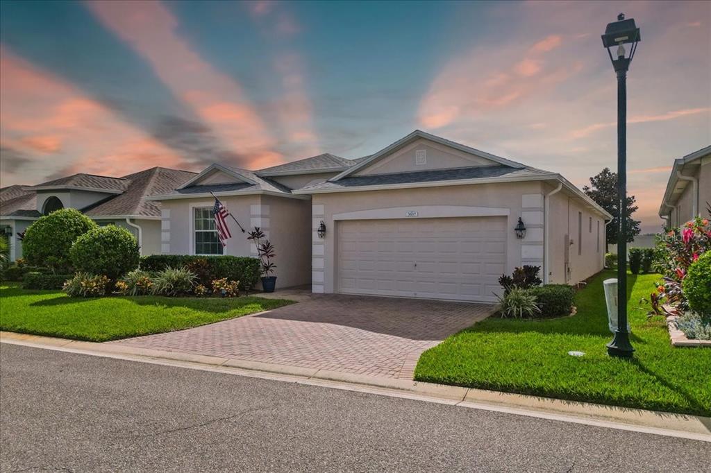 a front view of a house with a yard and garage