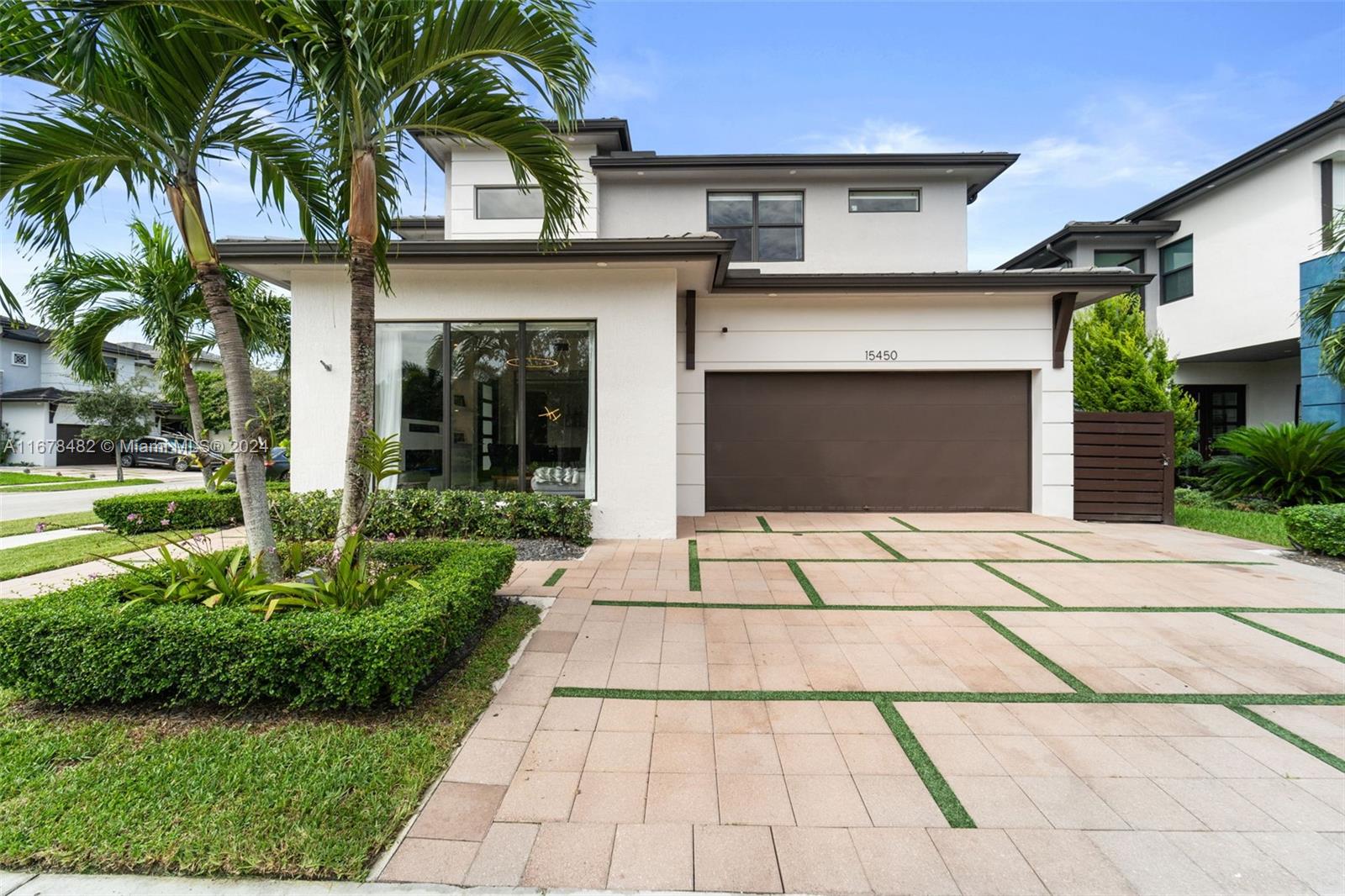 a front view of a house with a yard and a garage