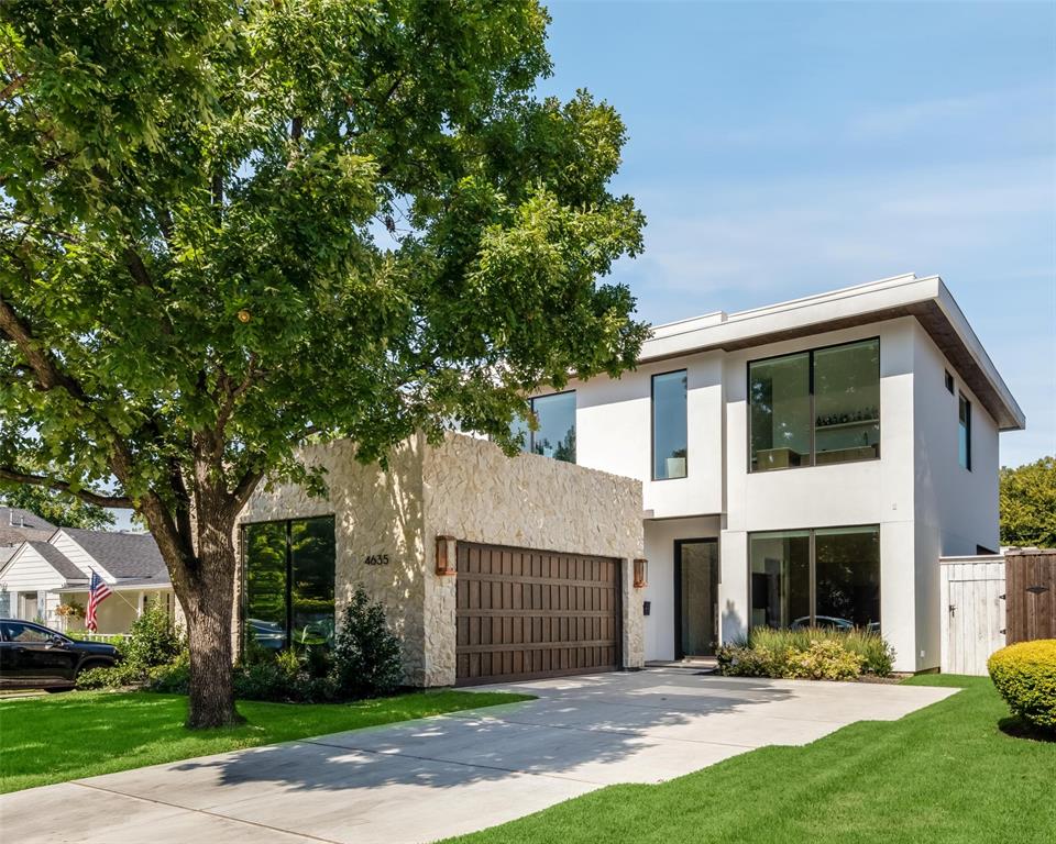 a view of a house with a yard and tree s