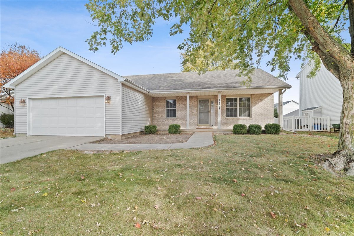 a view of a yard in front of a house with large tree