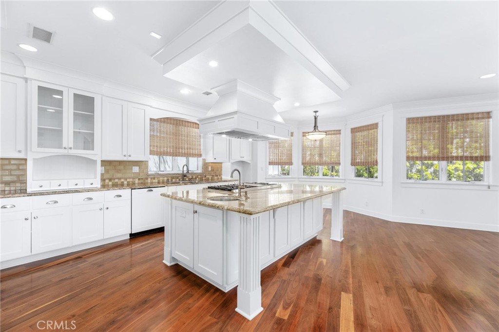 a kitchen with granite countertop a stove and cabinets