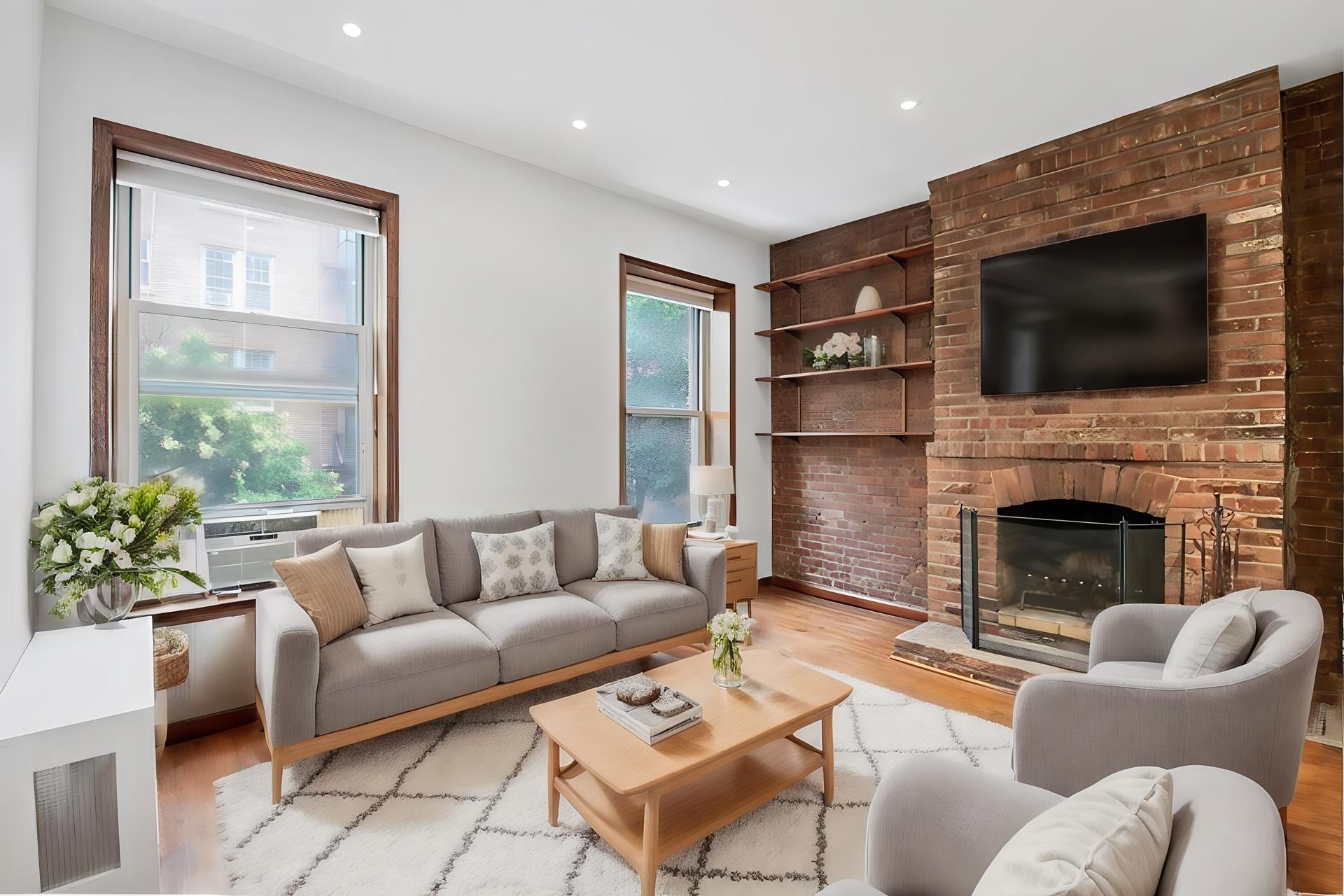 a living room with furniture a flat screen tv and a fireplace