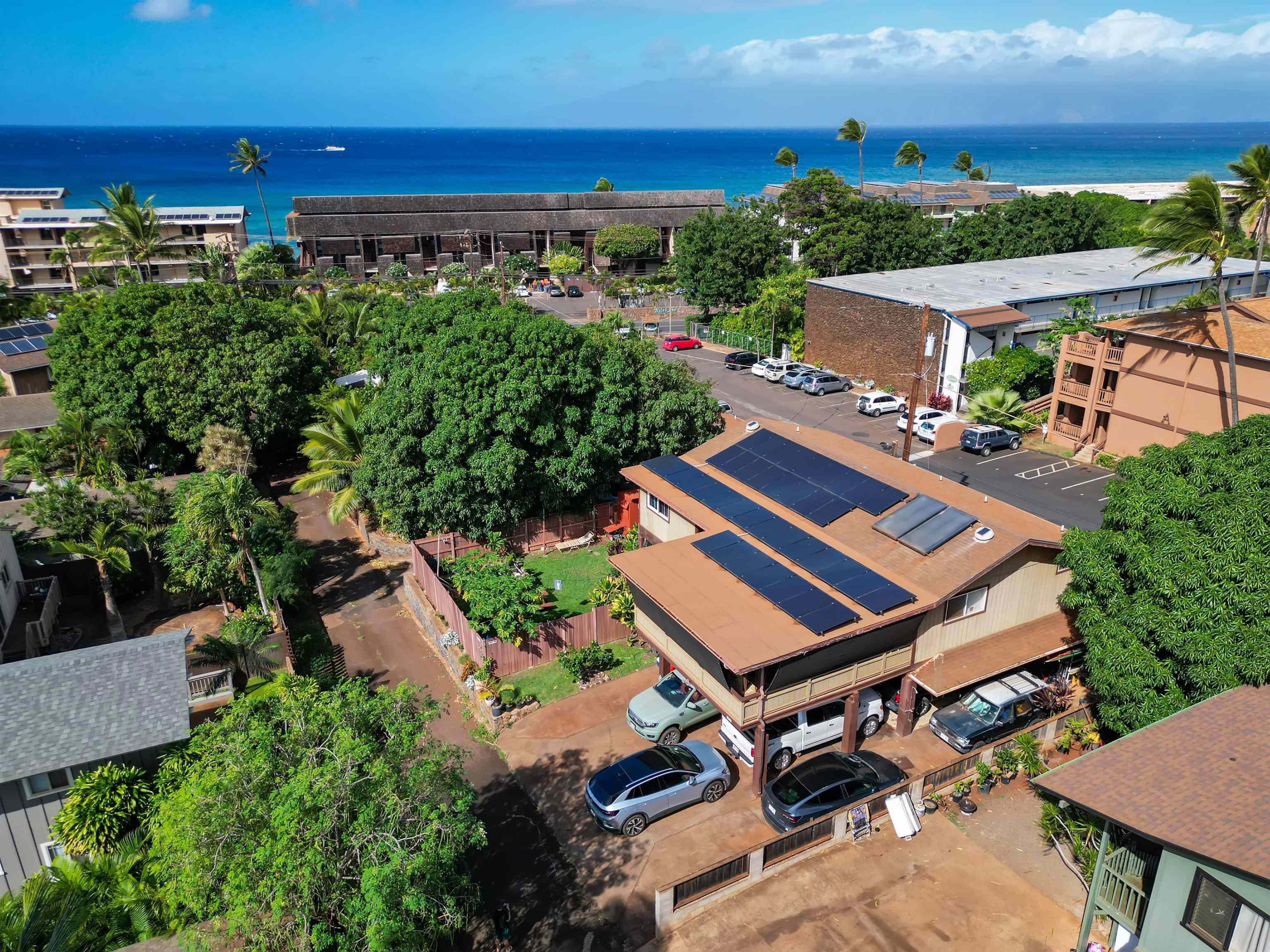 an aerial view of a house with a yard swimming pool and outdoor seating