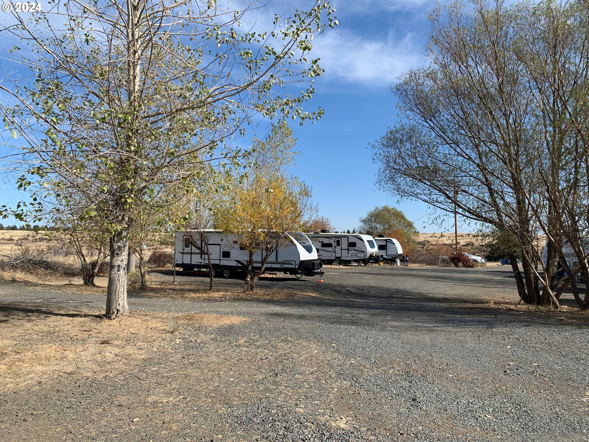 a view of road with parked cars