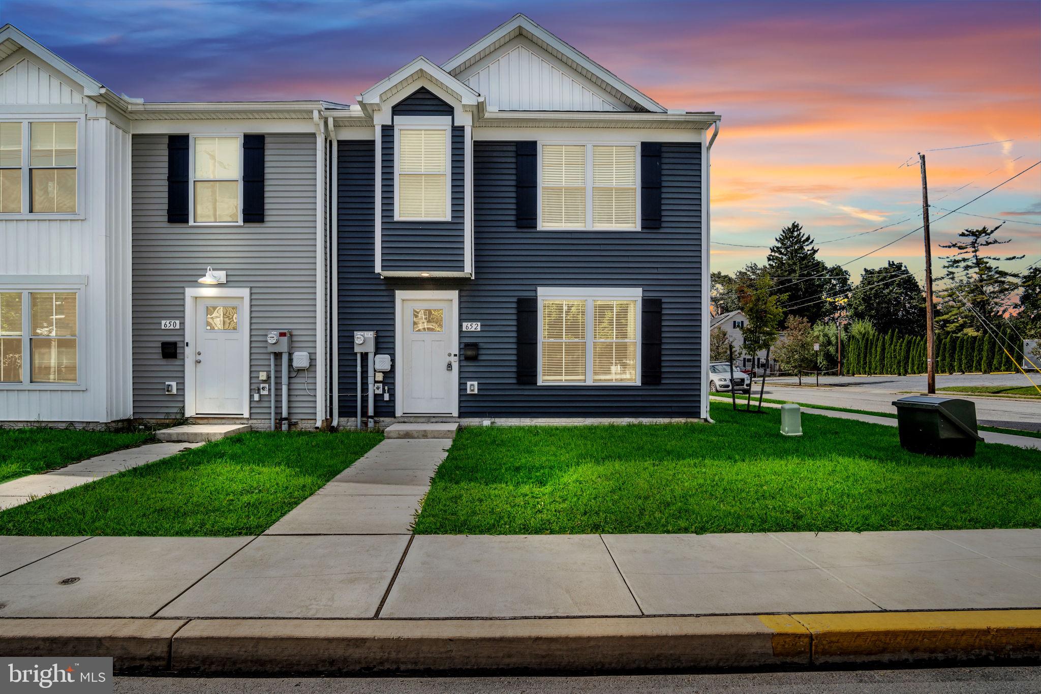 a front view of a house with a yard and a garage