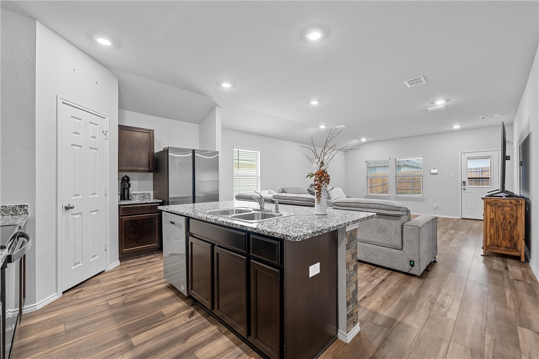 a kitchen with granite countertop counter top space a sink stainless steel appliances and cabinets