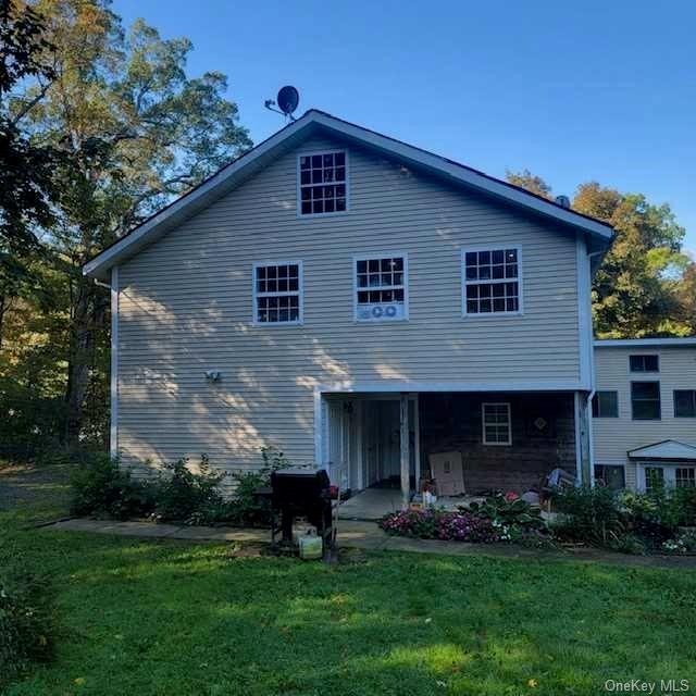 a front view of a house with a yard and garden