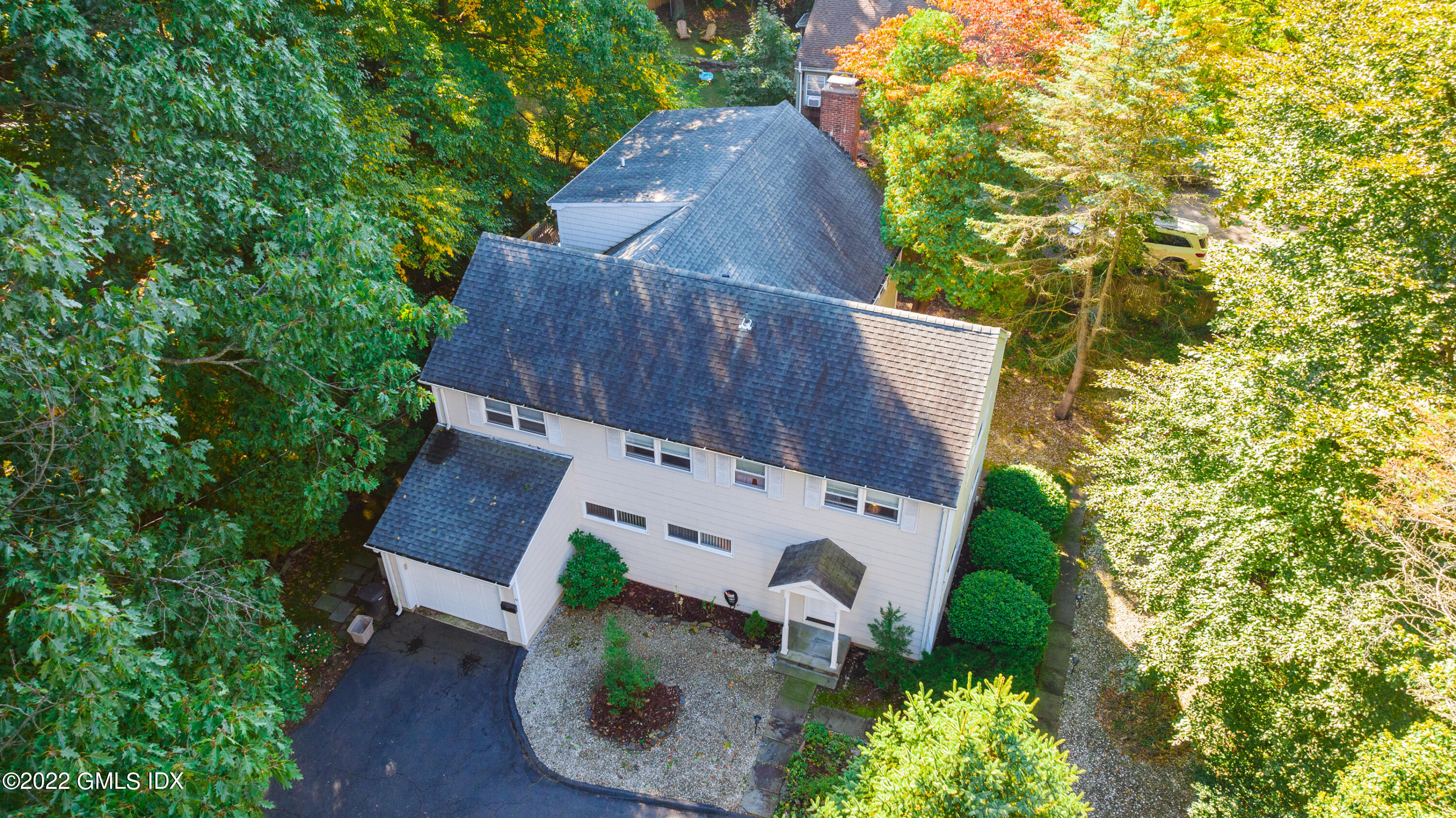 an aerial view of a house with garden space and sitting area