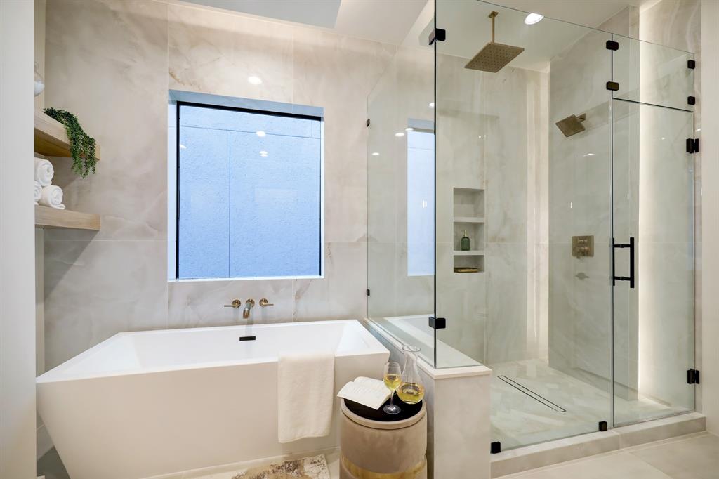 a bathroom with a tub and shower