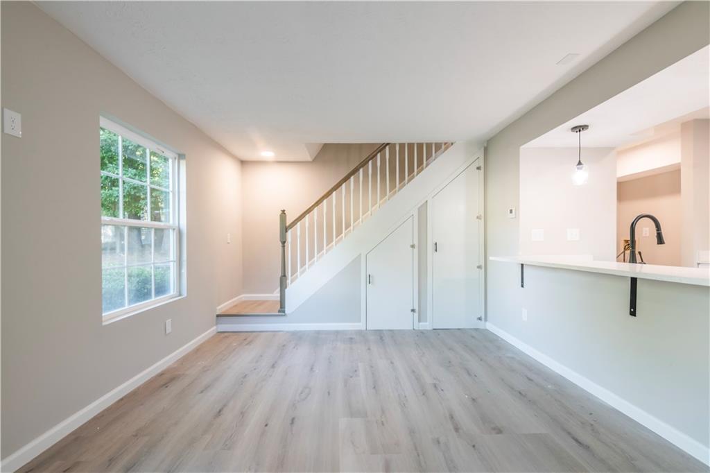 a view of a room with wooden floor and a window