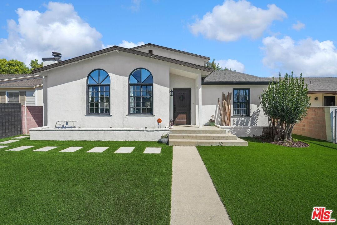 a view of a house with swimming pool and a garden