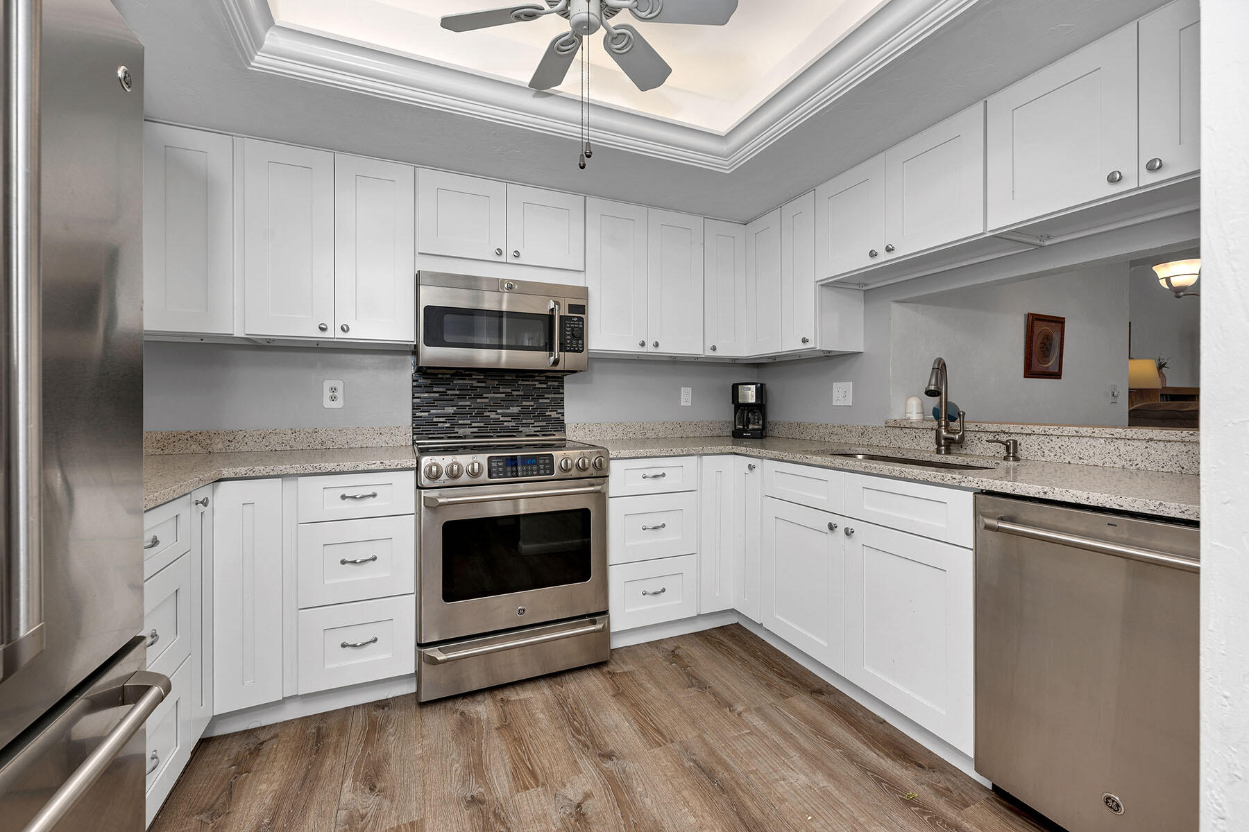 a kitchen with cabinets stainless steel appliances and a counter space