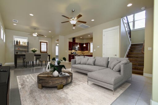 a living room with furniture and a view of kitchen