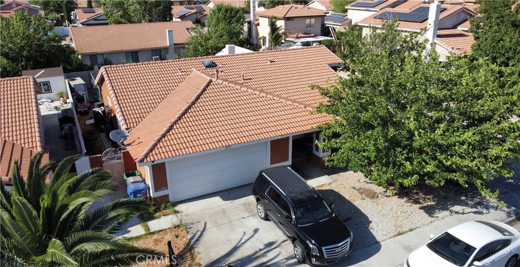 aerial view of a house with backyard and sitting area