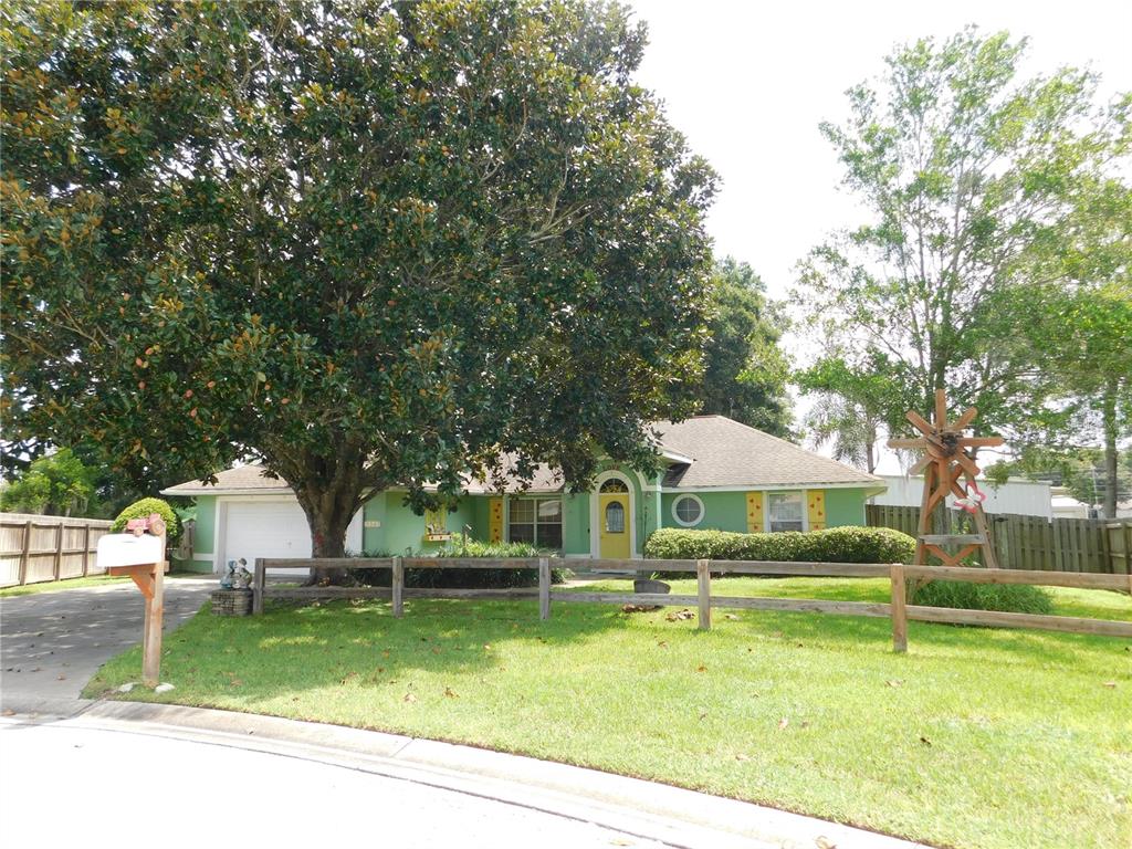 a view of house with swimming pool and trees in the background