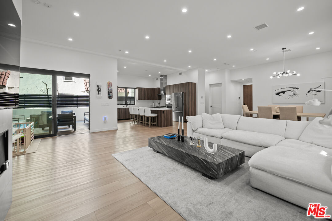 a living room with furniture and kitchen view