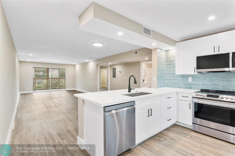 a kitchen with a sink stove and microwave