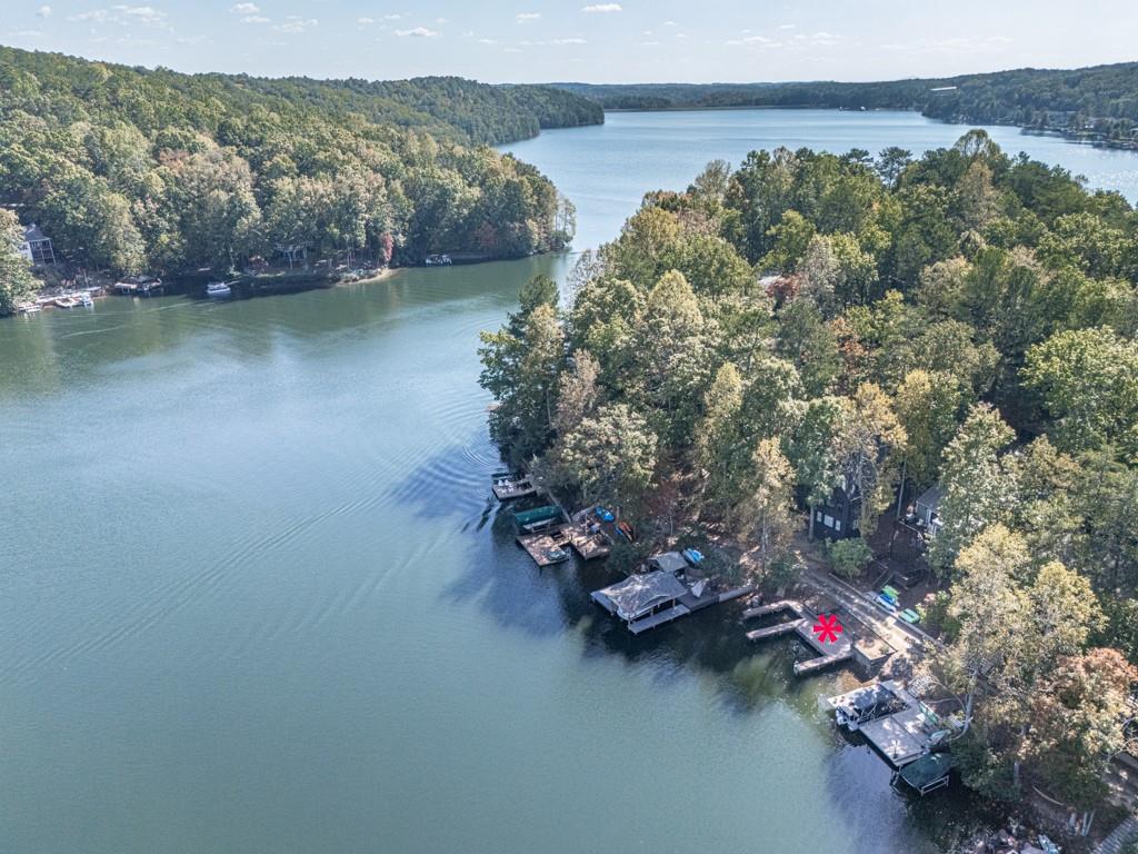 an aerial view of a house with a yard and lake view