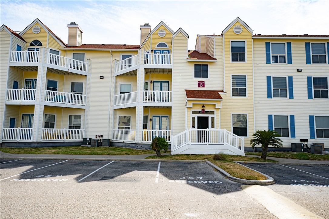 a front view of a residential apartment building with a yard