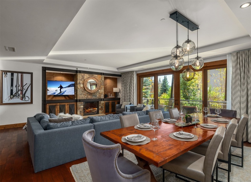 a dining room with furniture a large window and a chandelier