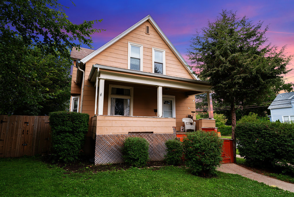 a front view of a house with garden