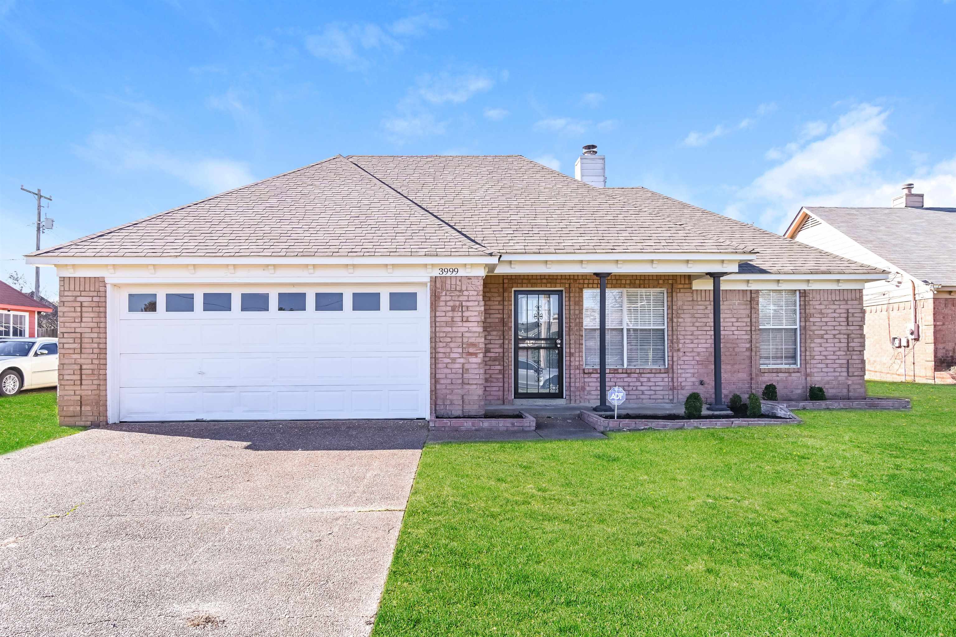 Ranch-style home with a garage and a front yard