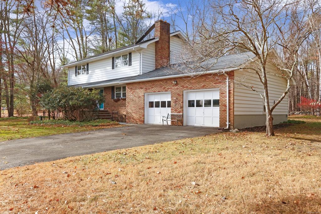 View of side of home featuring a yard