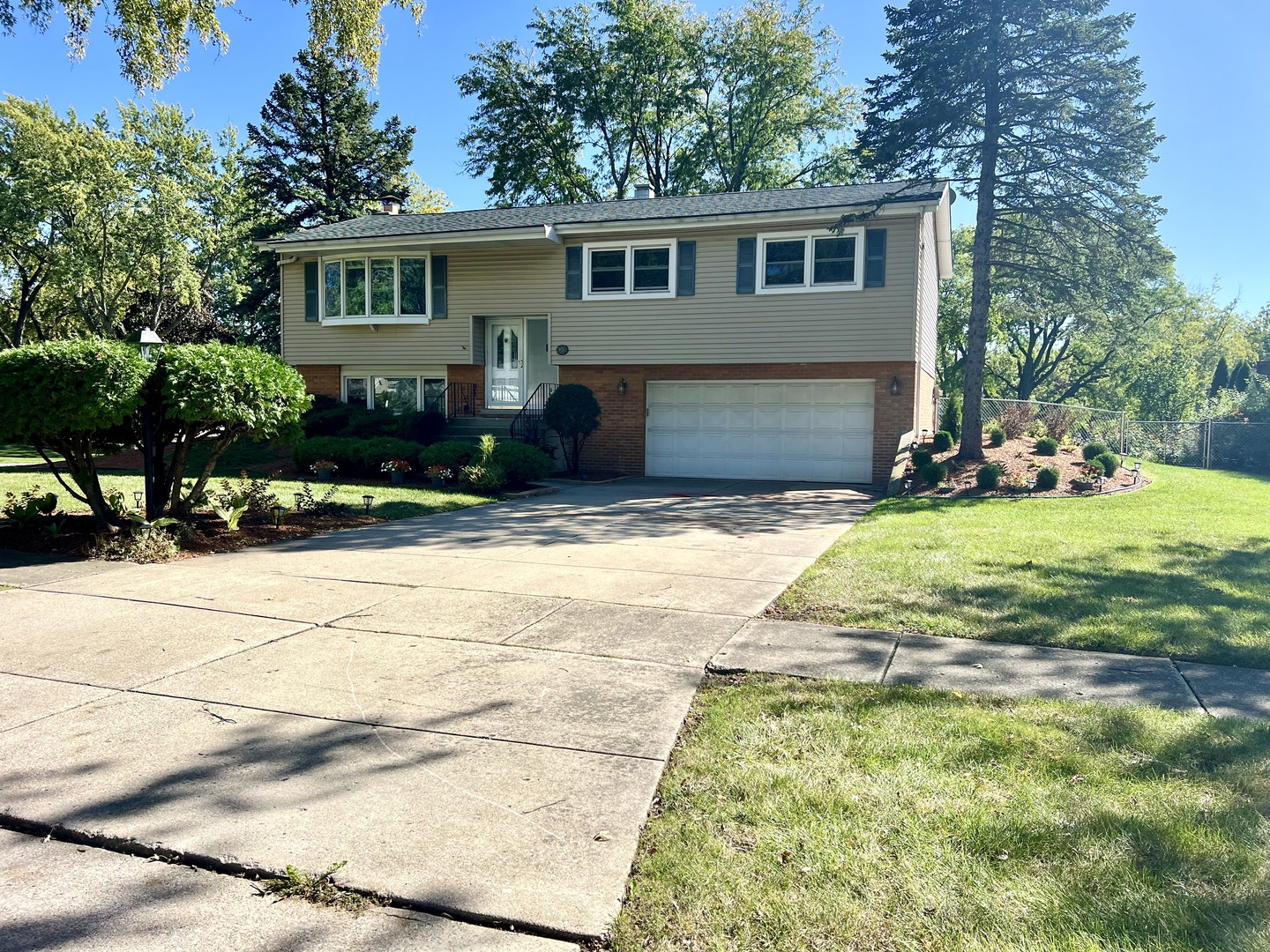 a view of a house with yard and sitting area