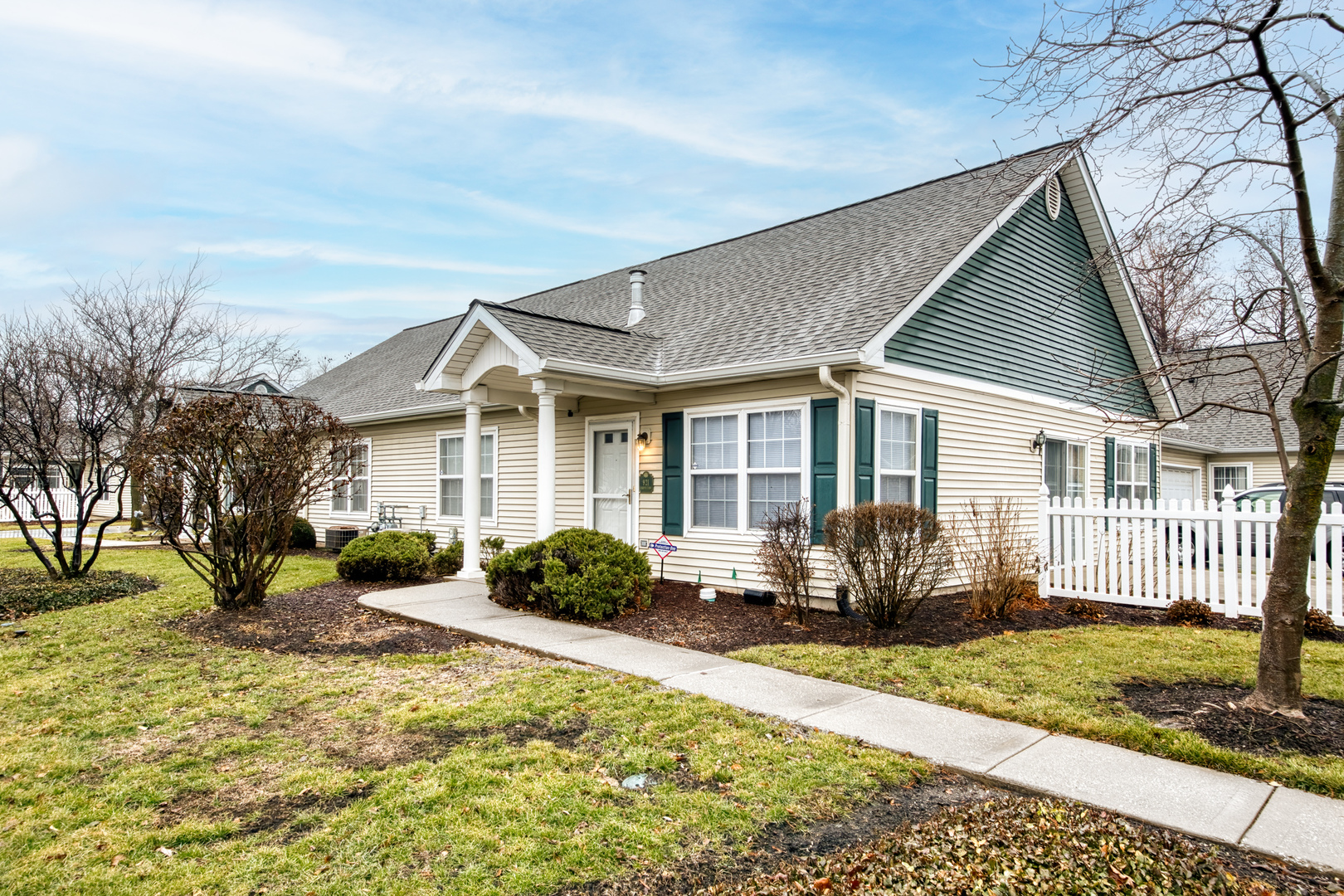 a front view of a house with a yard and outdoor seating