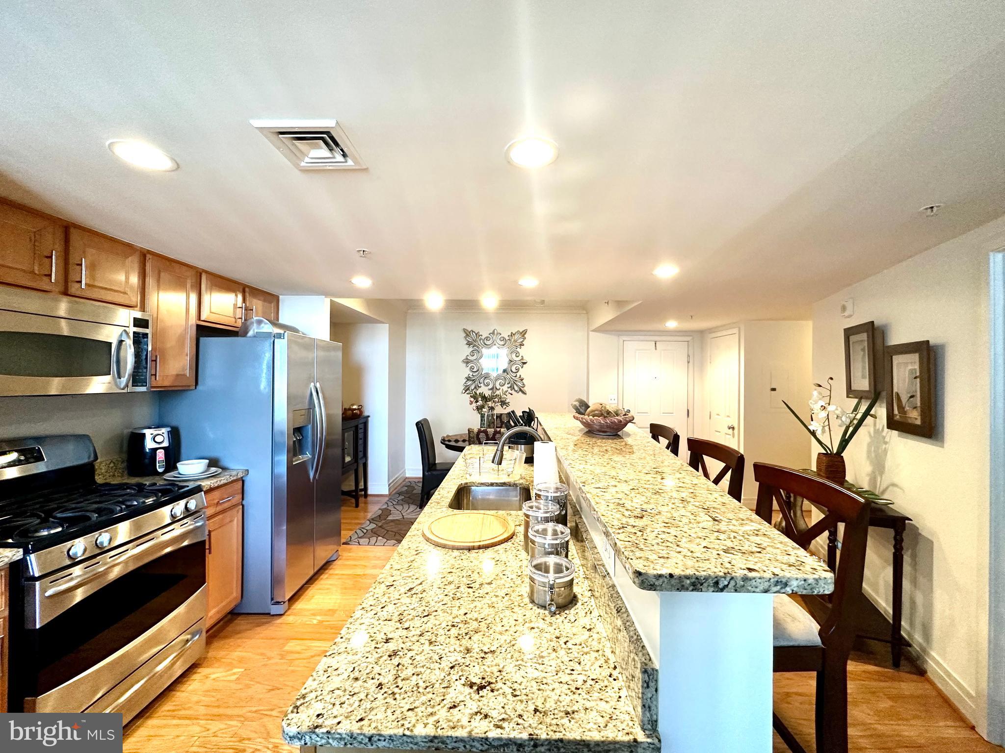 a large kitchen with a table and chairs in it