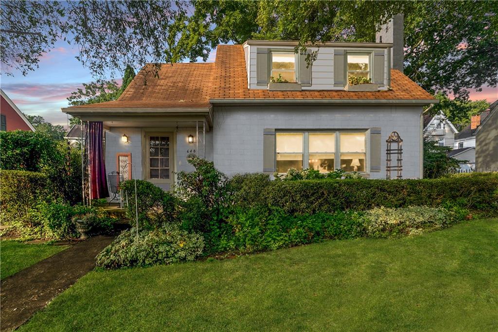 a front view of a house with a garden