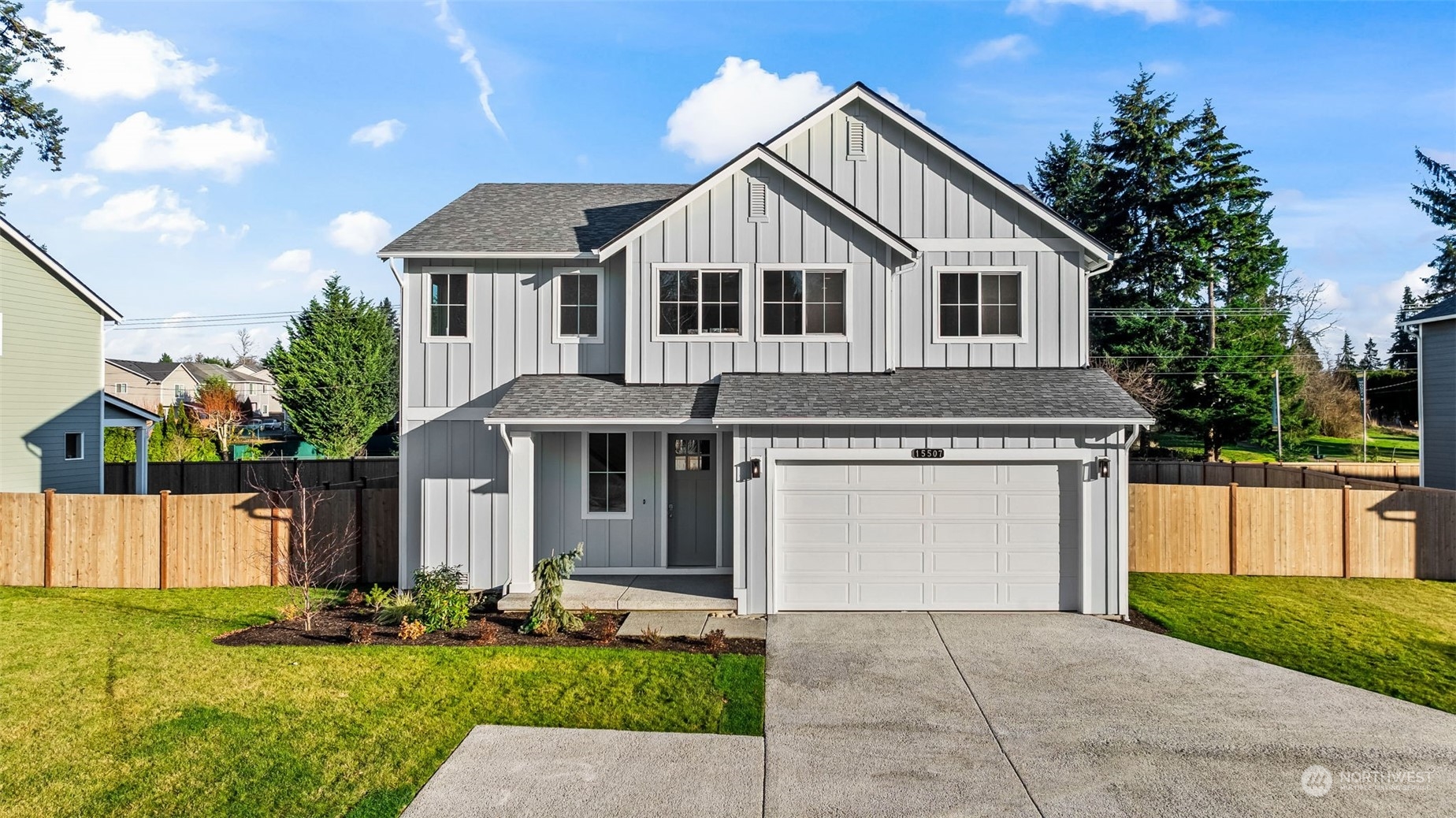 a front view of a house with a yard and garage