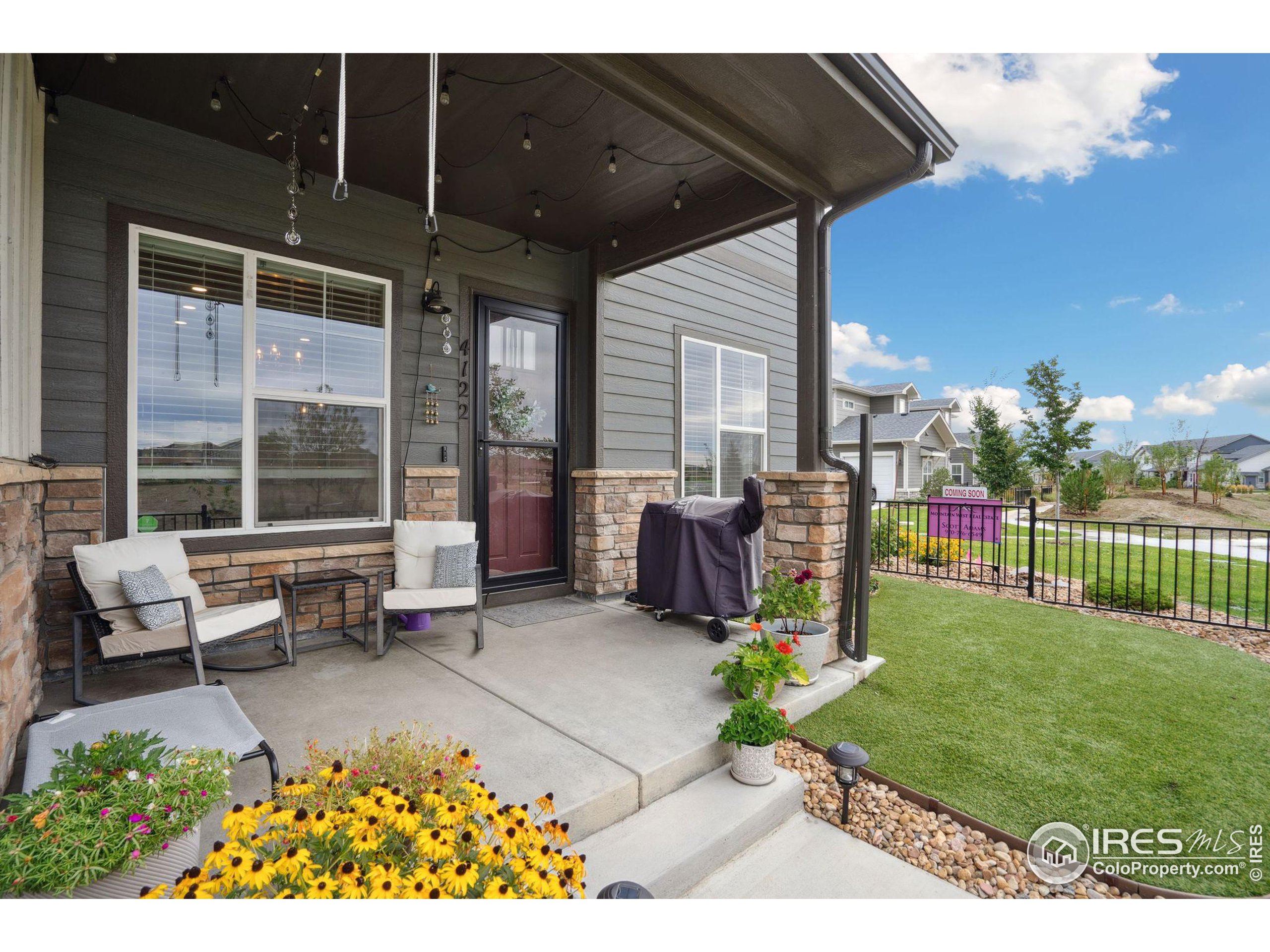 a view of a porch with furniture and garden