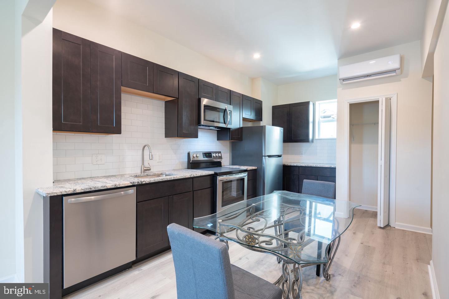 a kitchen with stainless steel appliances kitchen island granite countertop a sink and stove