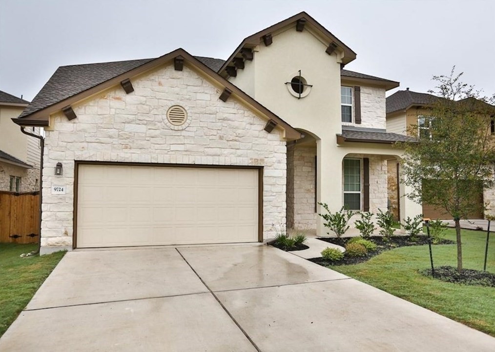 a front view of a house with garden