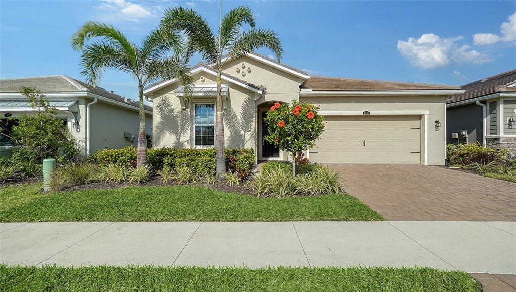 a front view of a house with a yard and a garage